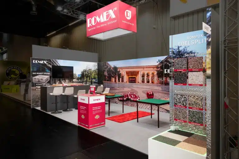 Messebau für Romex auf der GaLaBau Nürnberg mit roter Theke, Barhockern und Musterwand Rompox Edelsplit.